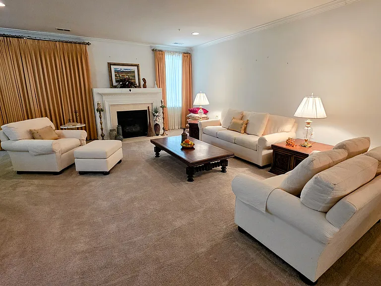 Bright and airy living area featuring a beautiful fireplace mantel, perfect for cozy evenings or vibrant social gatherings.