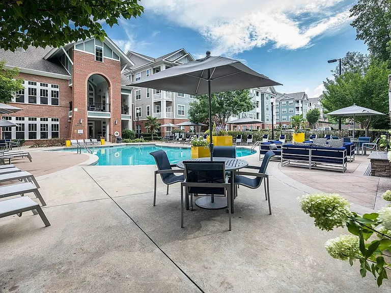 Resort-style pool deck with shaded seating, lounge areas, and modern clubhouserelaxed, upscale apartment living in Charlotte.