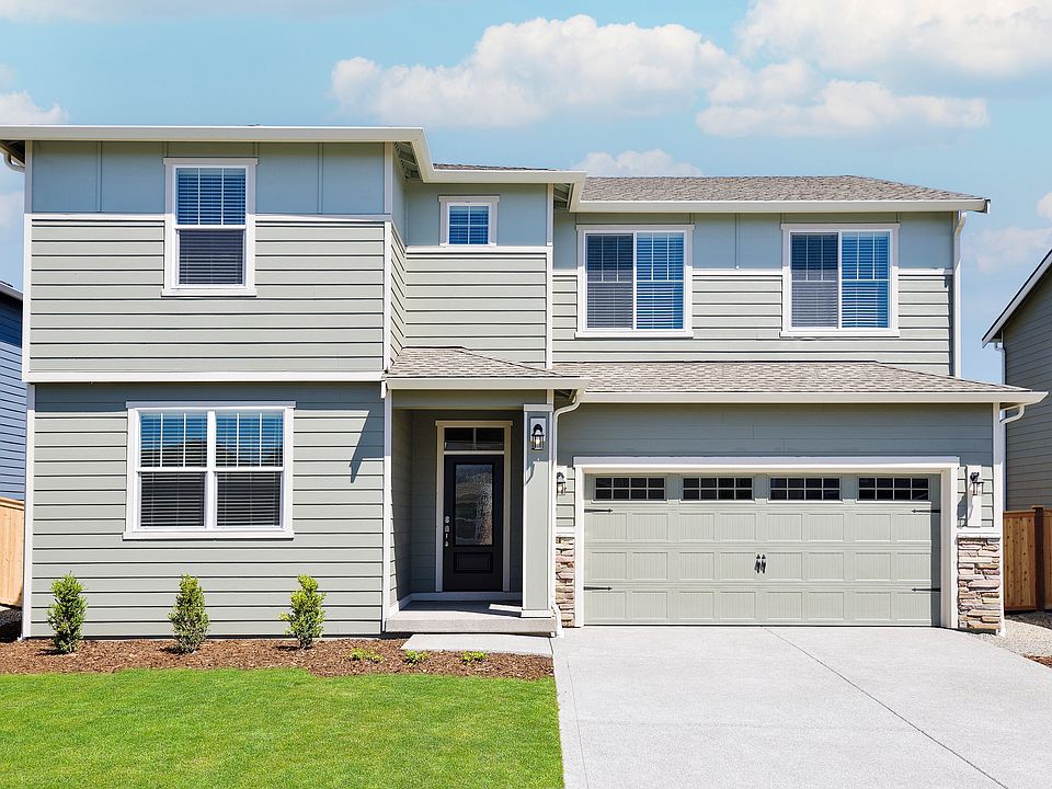 Beautiful two story home at Prairie Creek Farms with siding and stone and front yard landscaping