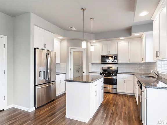 Beautiful kitchen with stainless steel appliances and white cabinets!