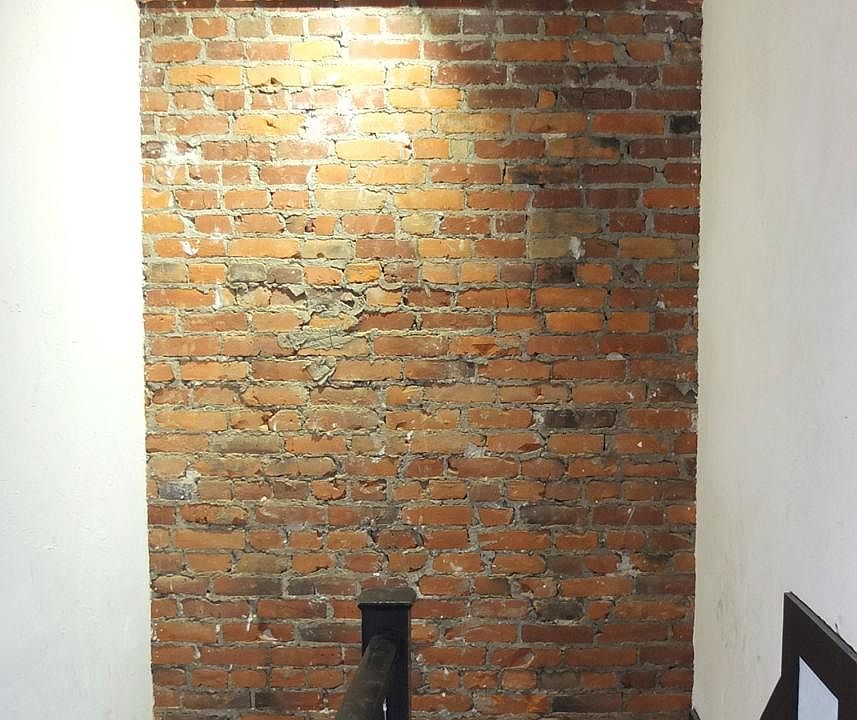 Original brick wall in stairway