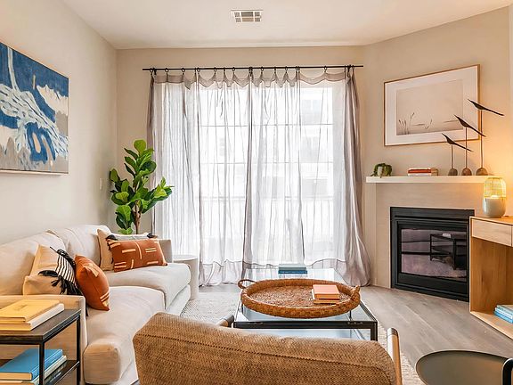 Cozy Living Room with Fireplace, Sheer Curtains, and Modern Decor