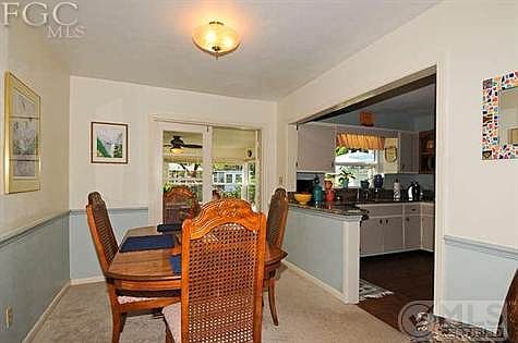 Dining room with chair rails and french doors to sunporch.