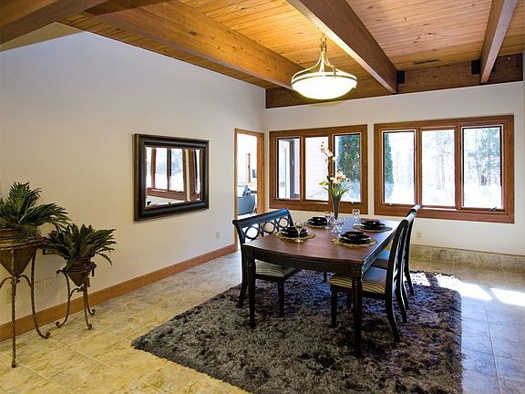 Heavy wooden beams support tongue & groove ceilings in lg. DR & throughout hm.