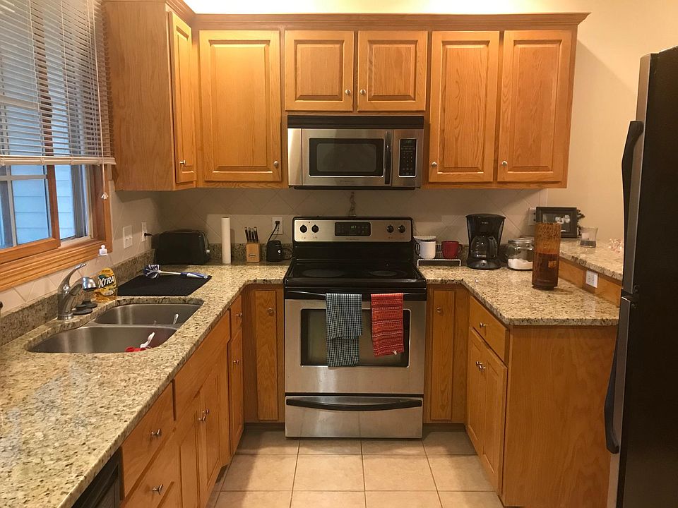 kitchen, granite counters, built in microwave, refrigerator, oven, dishwasher, stainless sink, tile backsplash, large south facing sunny kitchen window