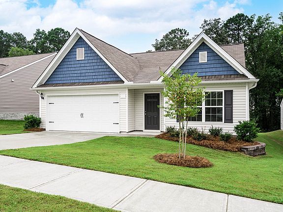 The Allatoona features front yard landscaping and charming shutters