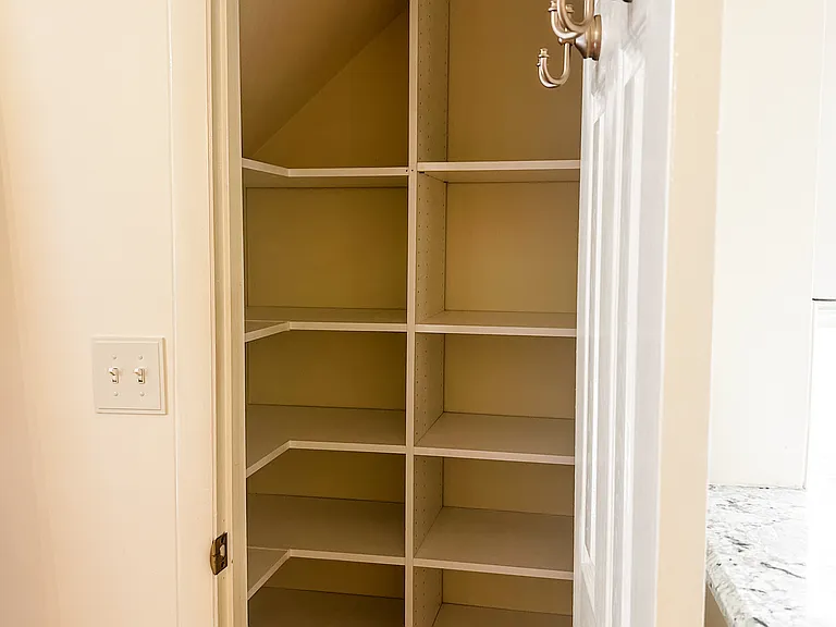 Main floor closet with built in shelving