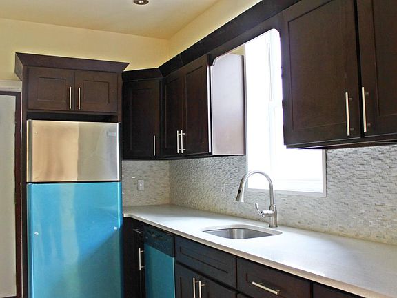 Modern, renovated galley kitchen with stainless steel applia
