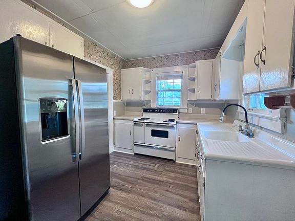 Kitchen with oven and new stainless steel refrigerator