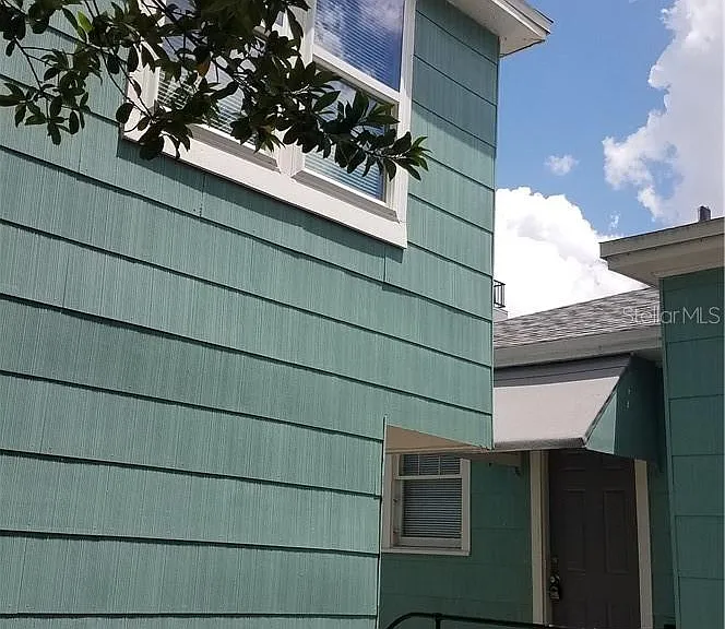 2nd fl apt bedroom window. Rear kitchen door & window to the rented 2 bed/2 bath Bungalow.