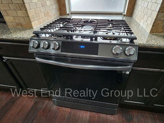 Gas range with electric convection oven