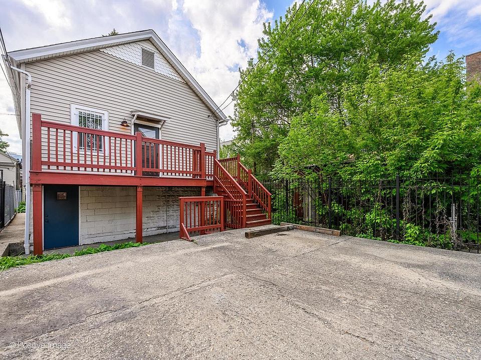 Rear entrance, parking pad and private deck
