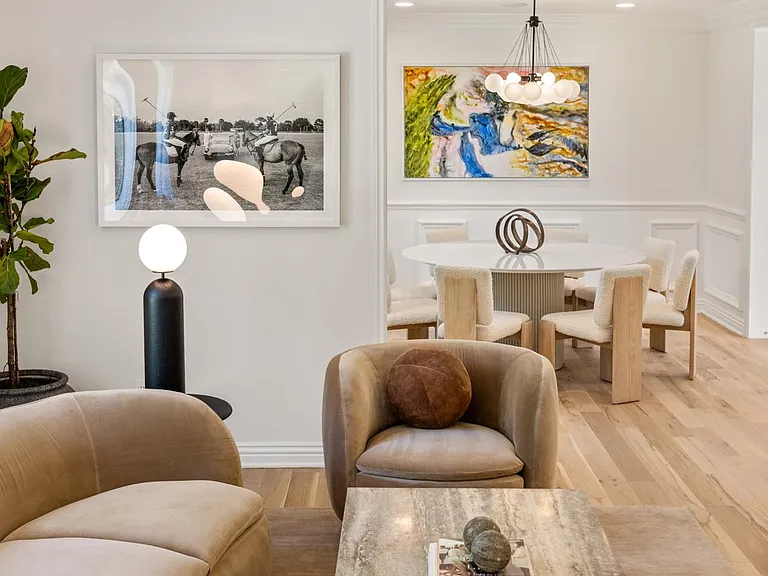 Unwind in the Formal Living Room, adorned with beautiful European sofa seating, a bar cart, and a cozy fireplace.