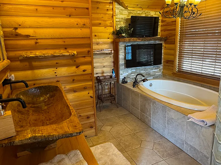 Master bathroom with large soaking tub and dough bowl sink for two.