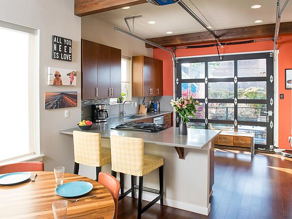 Dining Area & Kitchen w/ Garage Door to Balcony