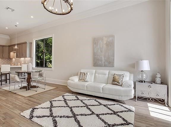 LIVING ROOM HAS FLOOR TO CEILING WINDOW WITH LOTS OF SUNSHINE BEAMING THRU.