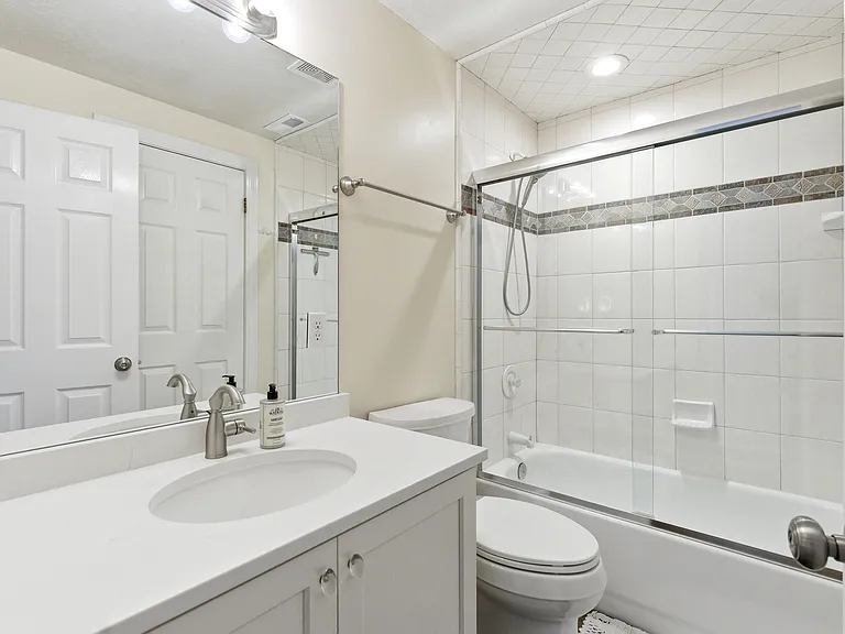 Bright full basement bathroom featuring a tub/shower combination.