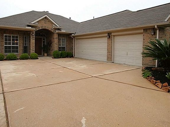 Three car attached garage with plenty of driveway space.