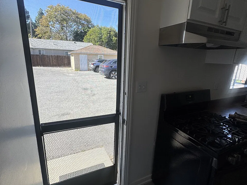 Door opens to parking area through kitchen