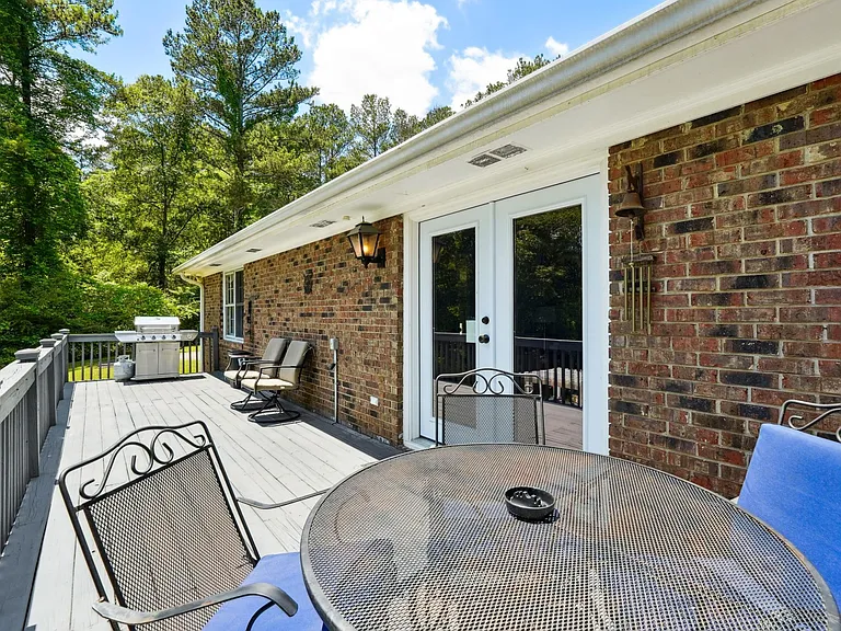 Upper back patio with outdoor furniture & BBQ gas grill off Main Level Living Room