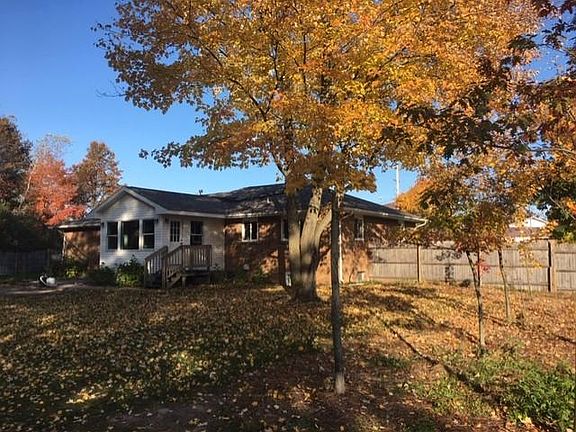 View of backyard and sunroom addition
