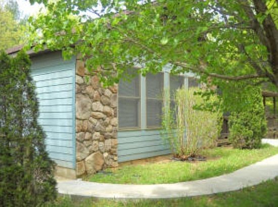 Another view of the front
						:
						The sidewalk extends across the front of the home to the back screened in porch