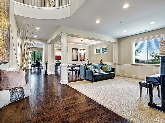 Grand Two Story Entry, with endless Hardwood Floors & Elegant Wainscoting Wood Panels and Columns