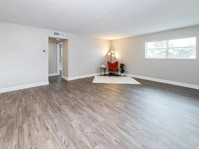 Feel pure comfort in your spacious living room, where your warm, wood-style flooring adds to the enjoyment of living at Boca Winds.