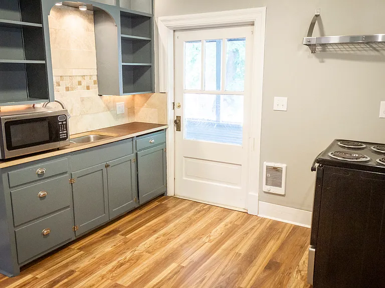 kitchen with door to private screened-in deck