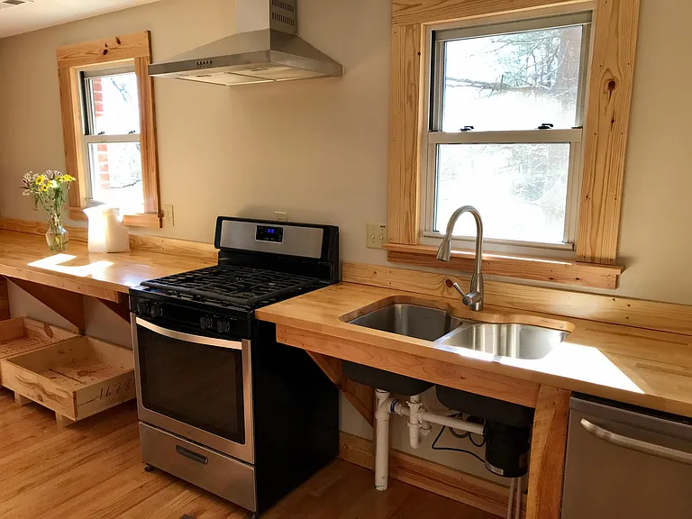 Kitchen. Hardwood oak floors, dishwasher, gas stove with hood, butcher block counters.