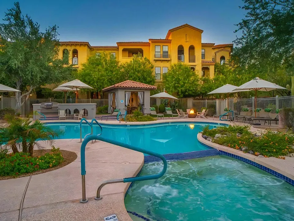 Swimming Pool Connected to Hot Tub with Poolside Firepit and Umbrellas