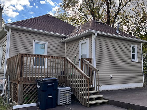 Back of house with small deck; off street parking is back here