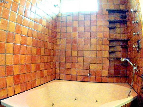 Large triangle hot tub in master bathroom