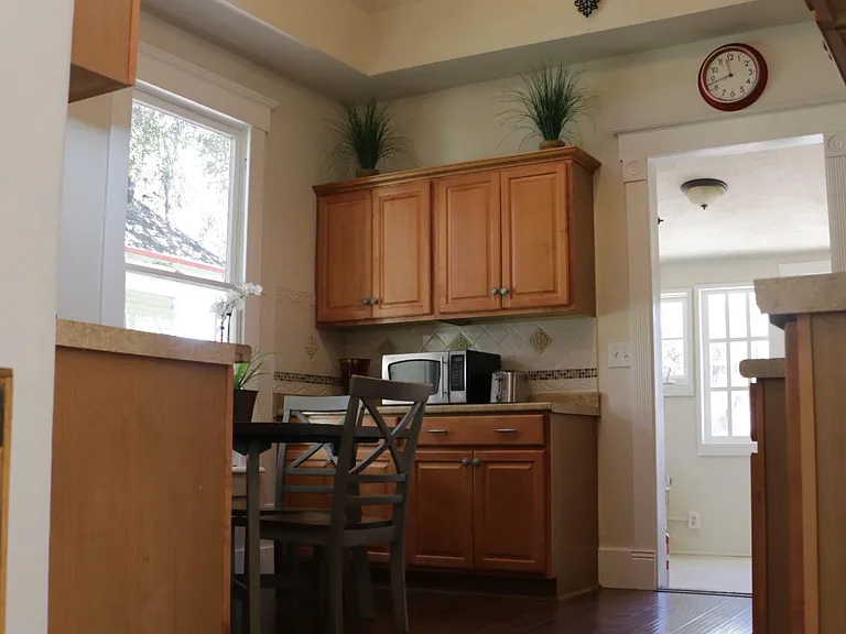 Good-sized Kitchen with plenty of storage and cabinetry, vaulted ceiling and VeLux skylight. Kitchen opens up to laundry room which overlooks backyard.