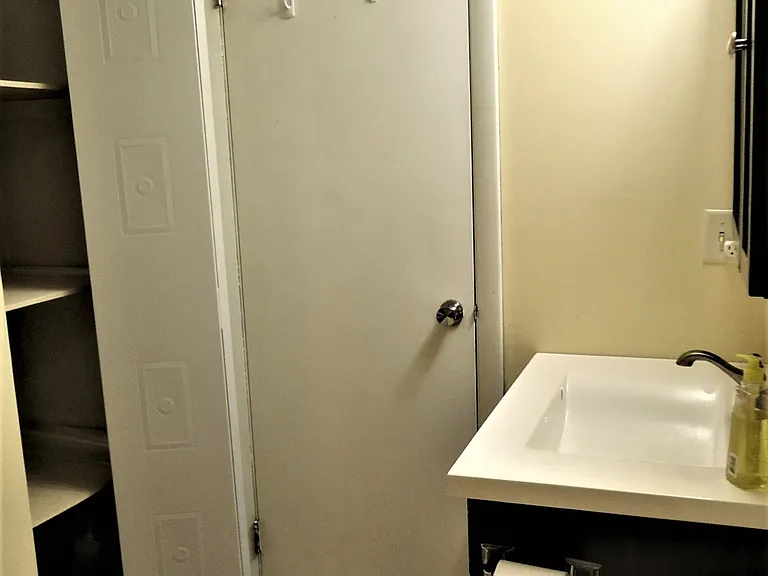 Closet behind door in Bathroom