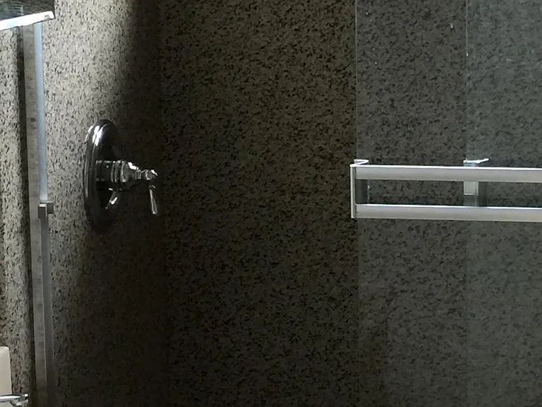 bathroom with granite walls to ceiling