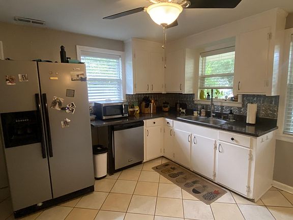 original cabinets, tin backsplash, stainless appliances