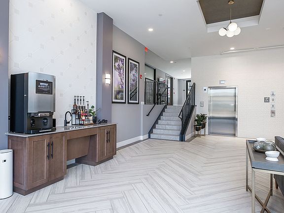 Hotel Style lobby with complimentary coffee bar, fireplace, seating and computer/printer