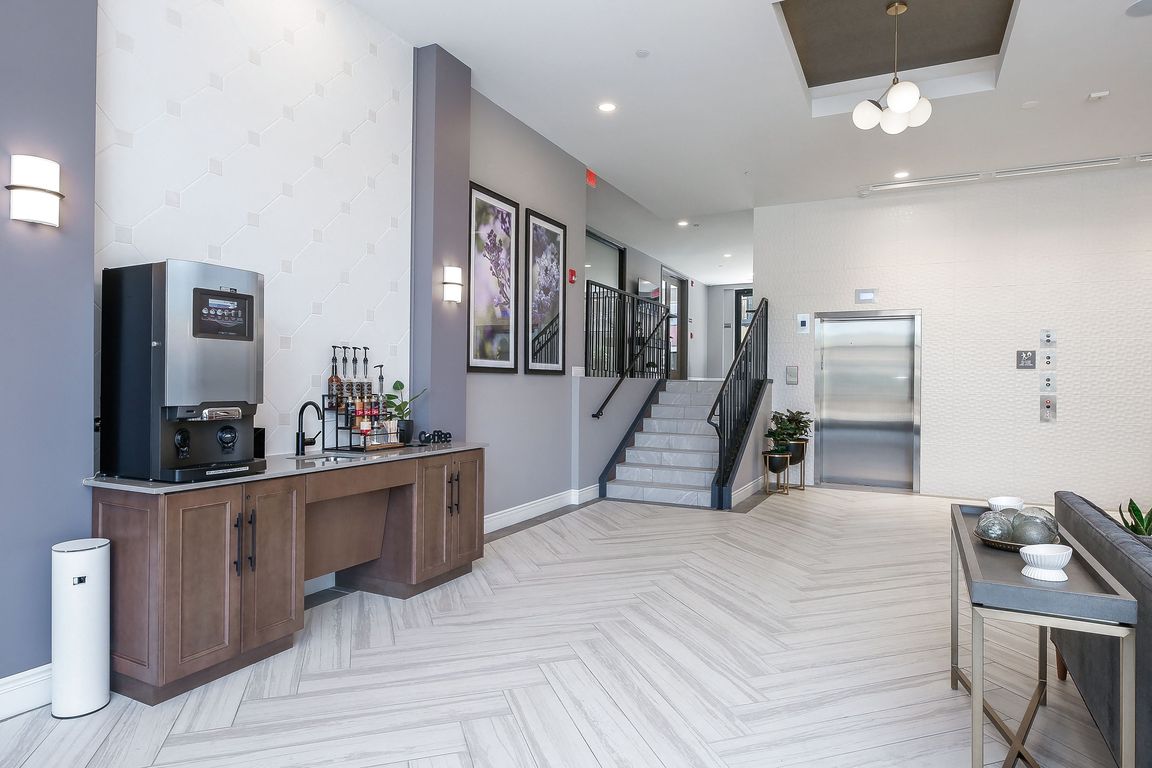 Hotel Style lobby with complimentary coffee bar, fireplace, seating and computer/printer