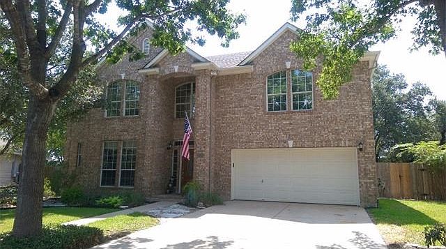Front of the house.Landscaped yard, large trees & side fence gates leading to the backyard on both sides of the house.