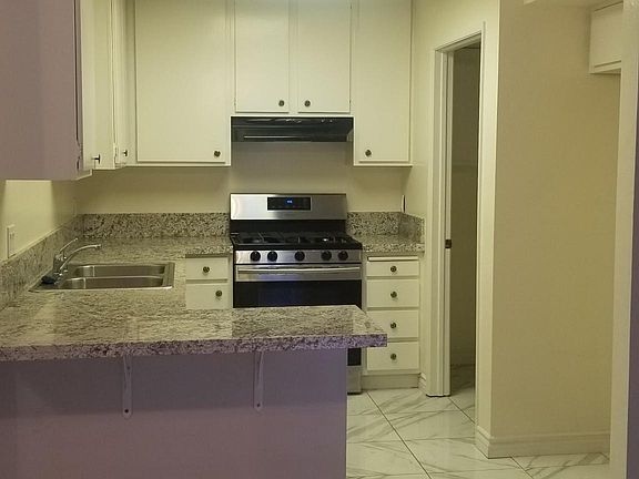 Kitchen with granite countertop and stainless steel stove/oven