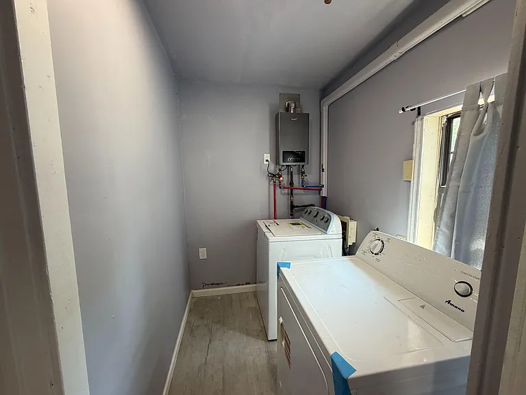 Dedicated laundry room with washer and dryer hookups and a window for ventilation and natural light.