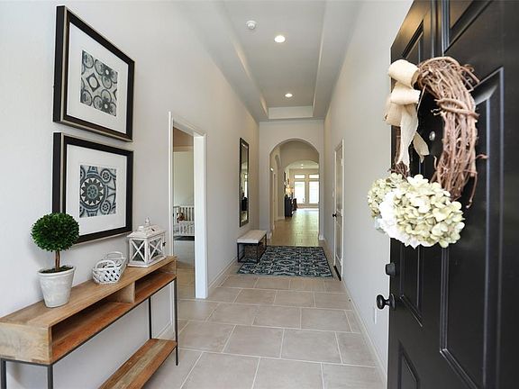 Greet your guests in the inviting front hallway. The tall ceilings and well lighted area offers a spacious and warm feeling upon entry.