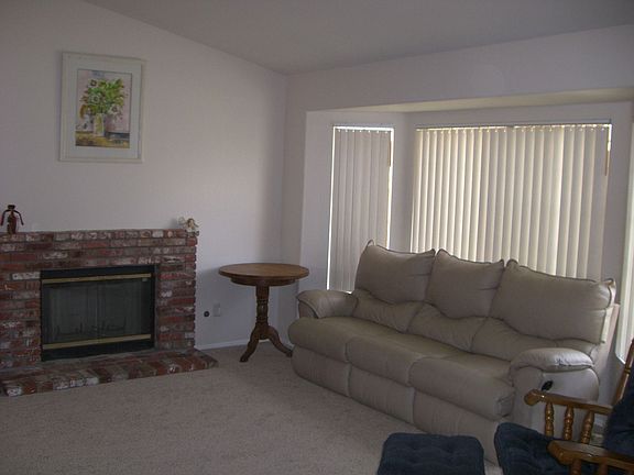 Family room w/ fireplace and new carpet.