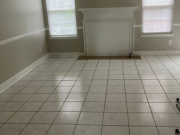 Large Living Room with Tile Flooring and Natural Light