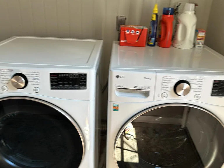 laundry room with full size front load washer and dryer