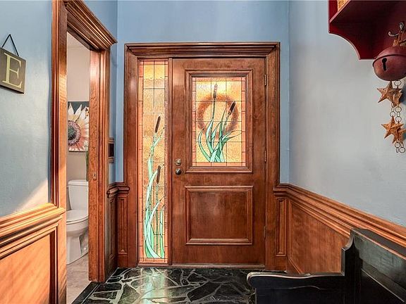 Welcoming Foyer with Exquisite Stained Glass Front Door