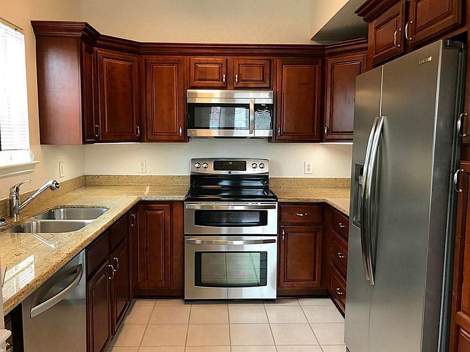 A GREAT kitchen with hardwood cabinets, under-mount lighting, granite counters and stainless steel a