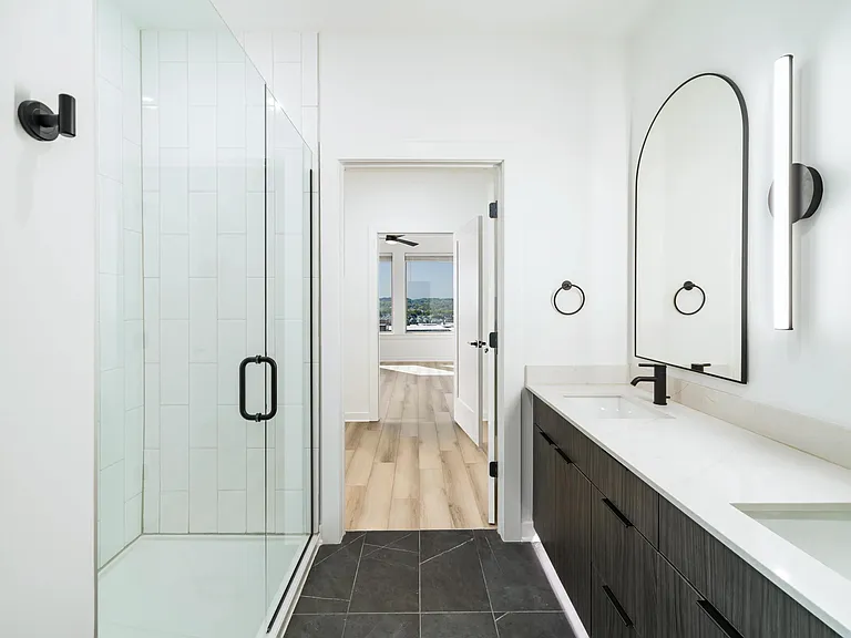 A sleek primary bath at Modera Nations in Nashville showcases spa-inspired design with the option to choose light or dark finishes to suit your style.
