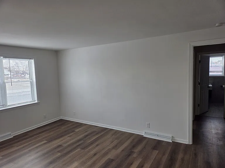 Looking right from the front door you see the rest of the living room and the hallway to the bathroom and bedroom.